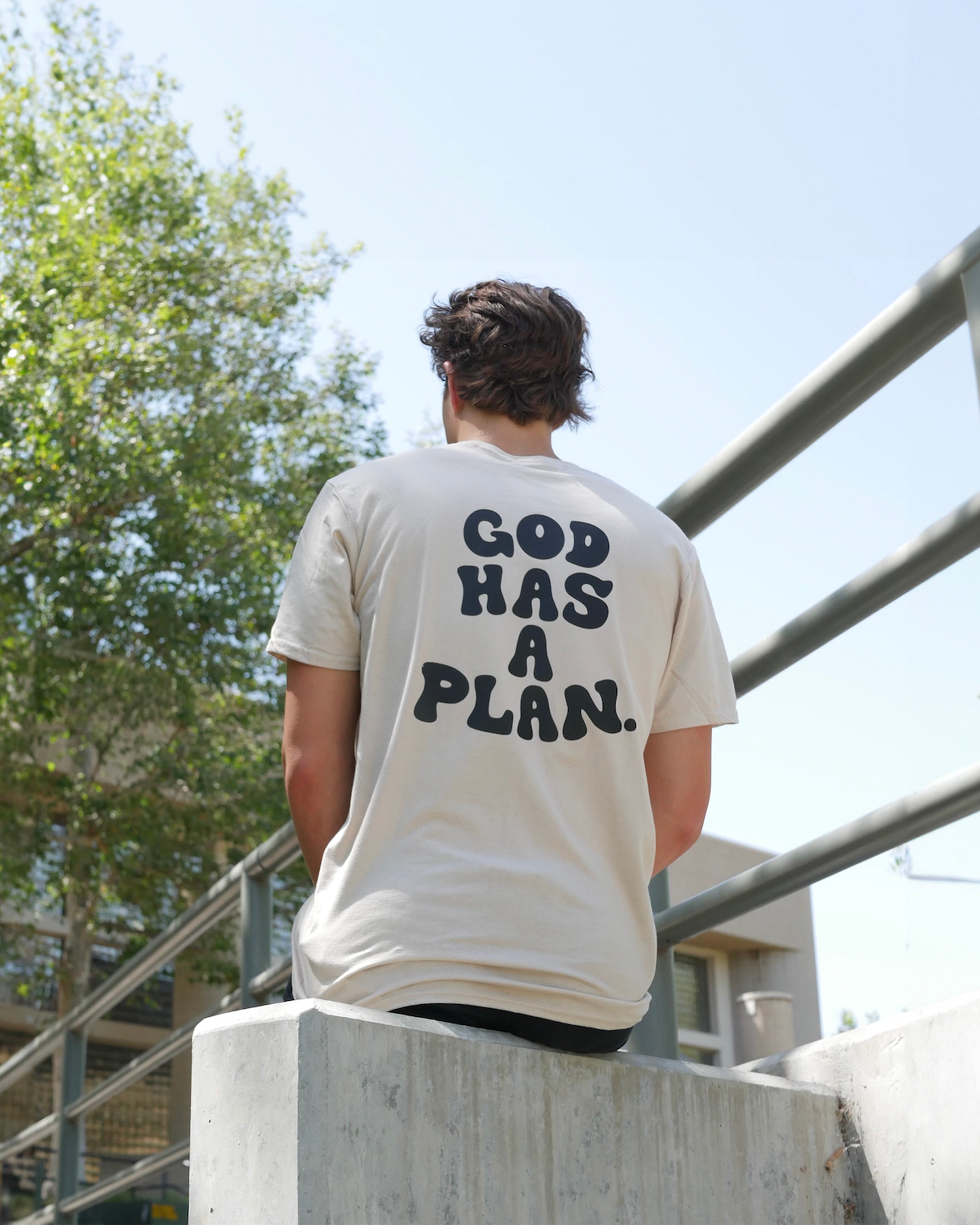 Beige tee mid range shot GOD HAS A PLAN TEE Christian streetwear t-shirt by Thank God featuring GOD HAS A PLAN TEE style