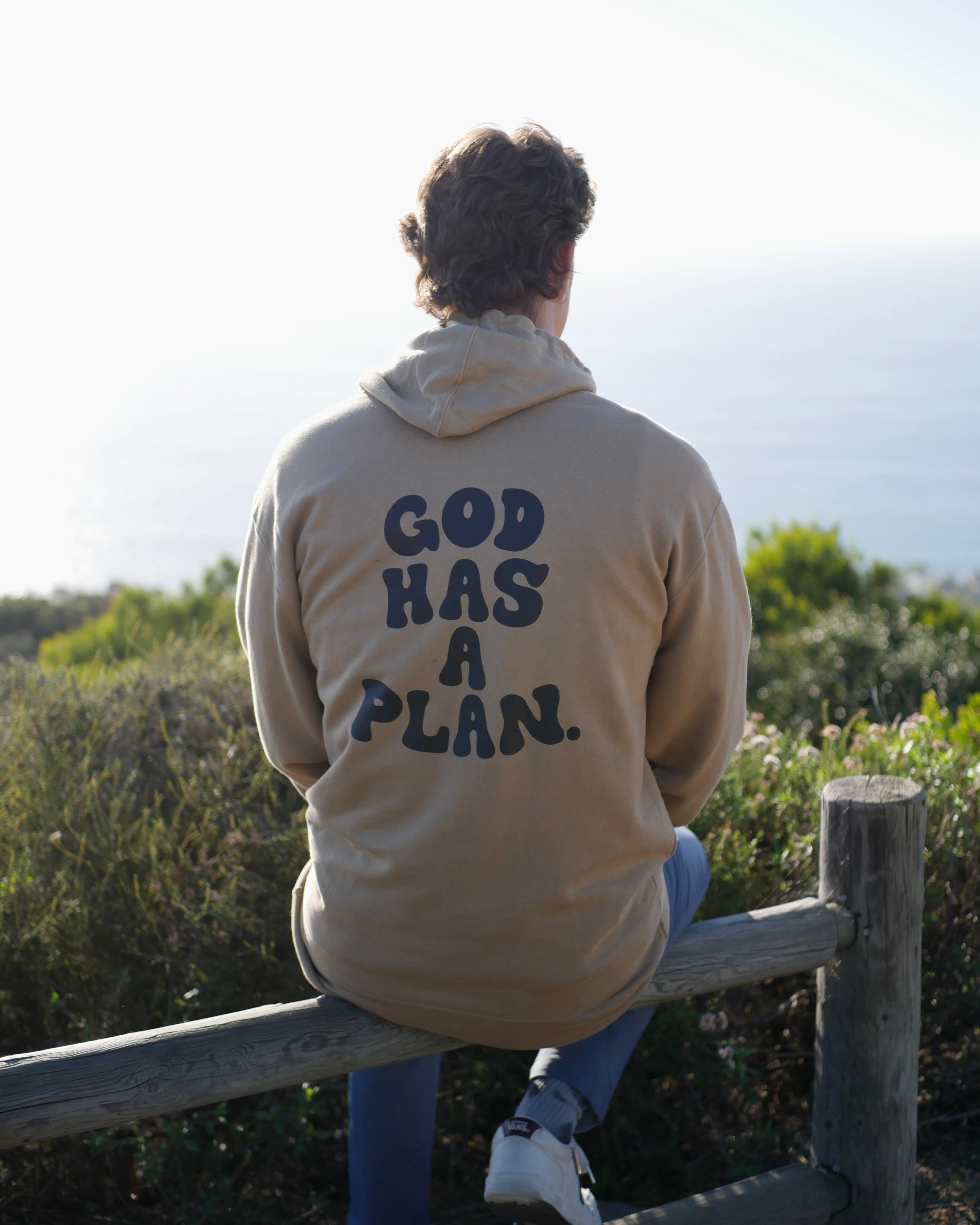 beige hoodie sit down shot GOD HAS A PLAN PREMIUM STRINGLESS HOODIE Faith-based Christian hoodie by Thank God with unique GOD HAS A PLAN PREMIUM STRINGLESS HOODIE design