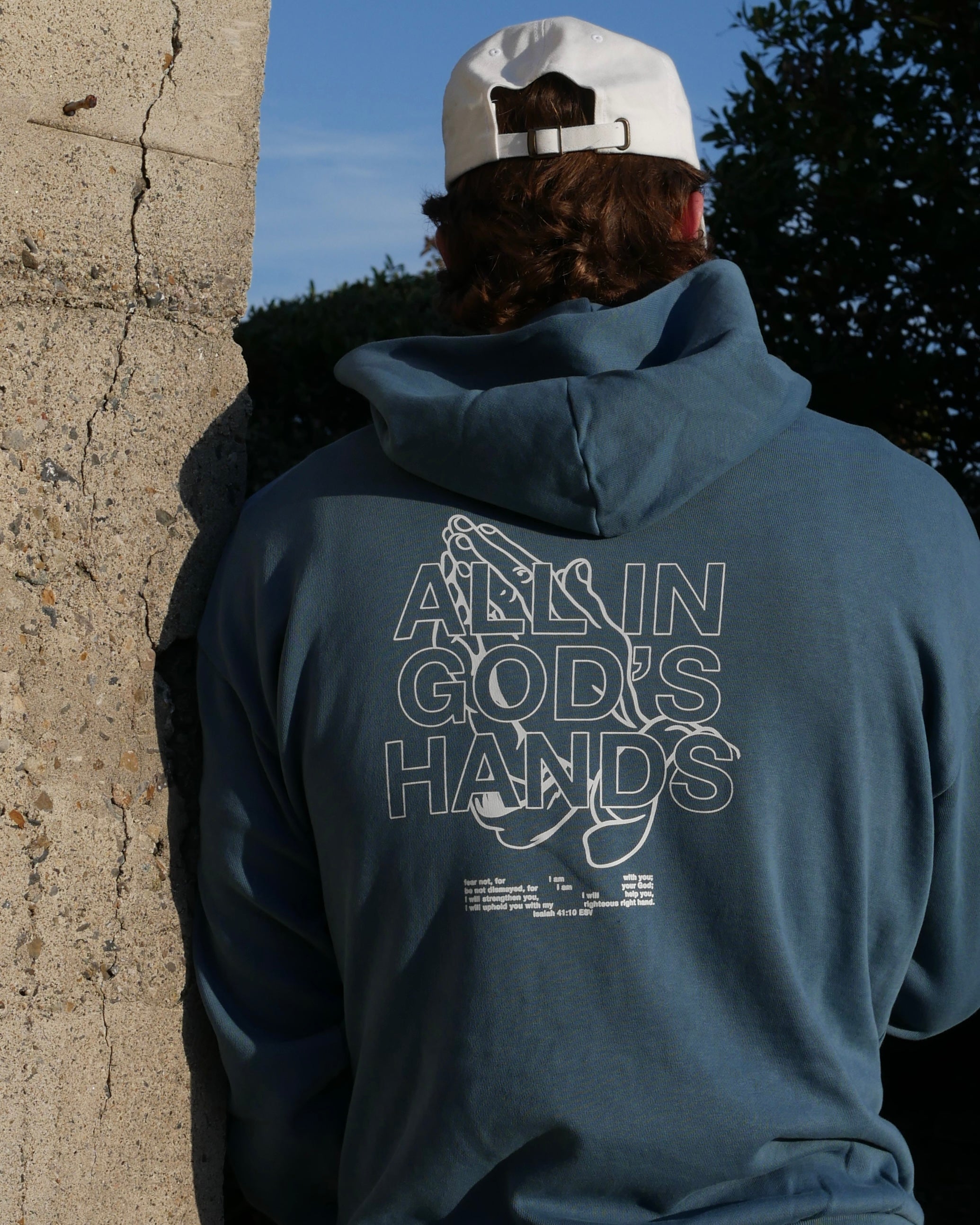 blue back close up design IN GOD'S HANDS HOODIE Faith-based Christian hoodie by Thank God with unique IN GOD'S HANDS HOODIE design