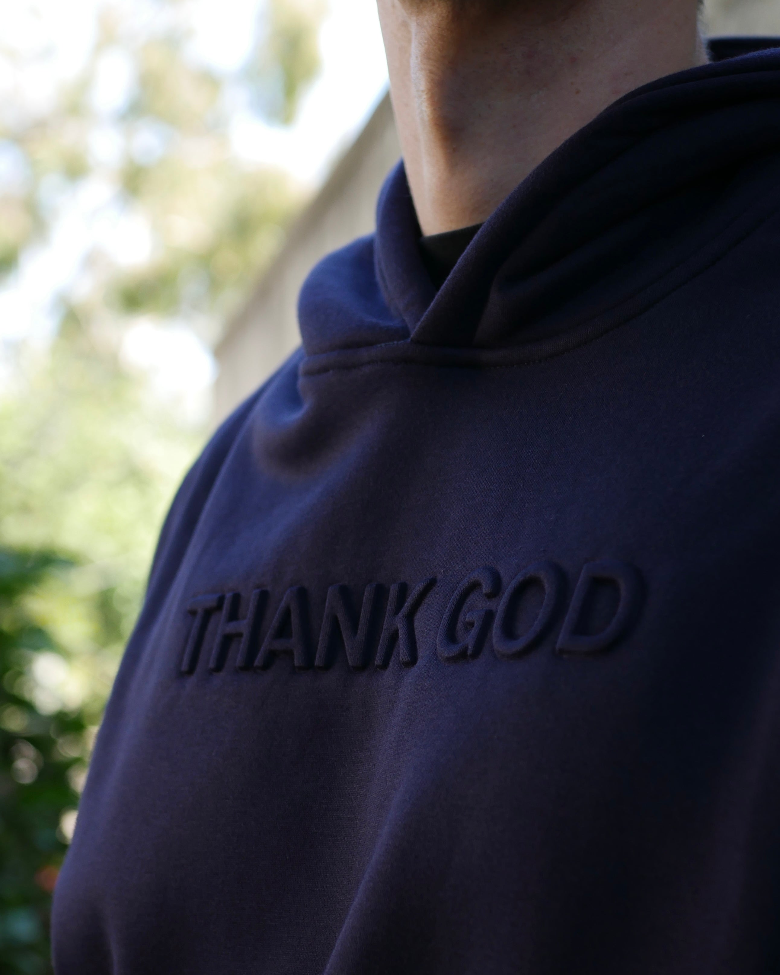 close up navy midnight Faith-based Christian hoodie by Thank God with unique EMBOSSED HOODIE design